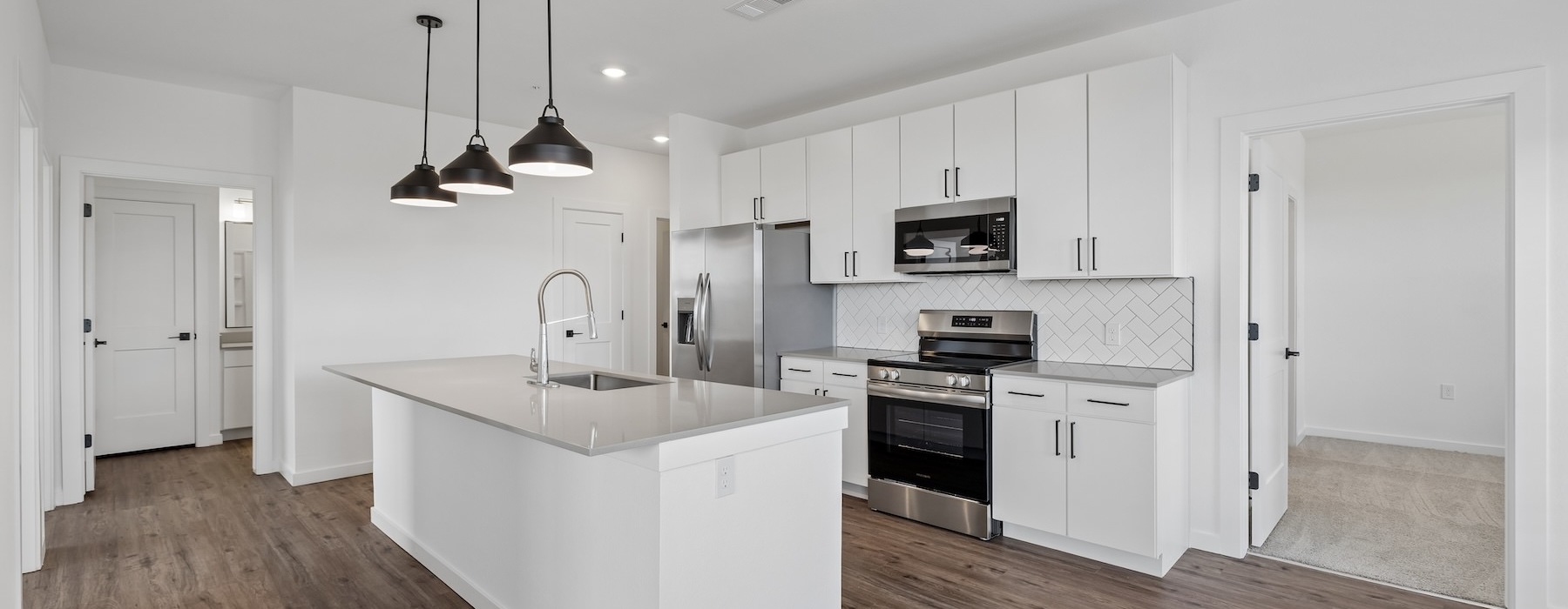 a kitchen with white cabinets