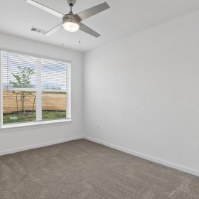 a bedroom with carpet and white walls