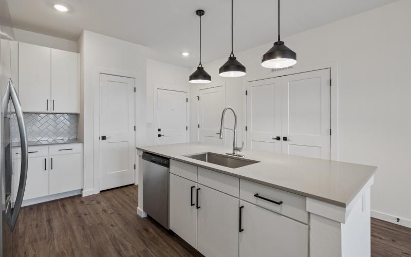 a kitchen with white cabinets