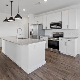 a kitchen with white cabinets